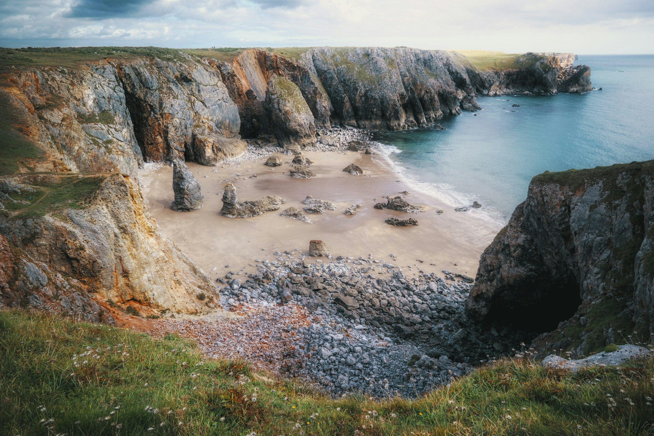 Aerial coastline geometry with tidal lines and cliff-like forms.